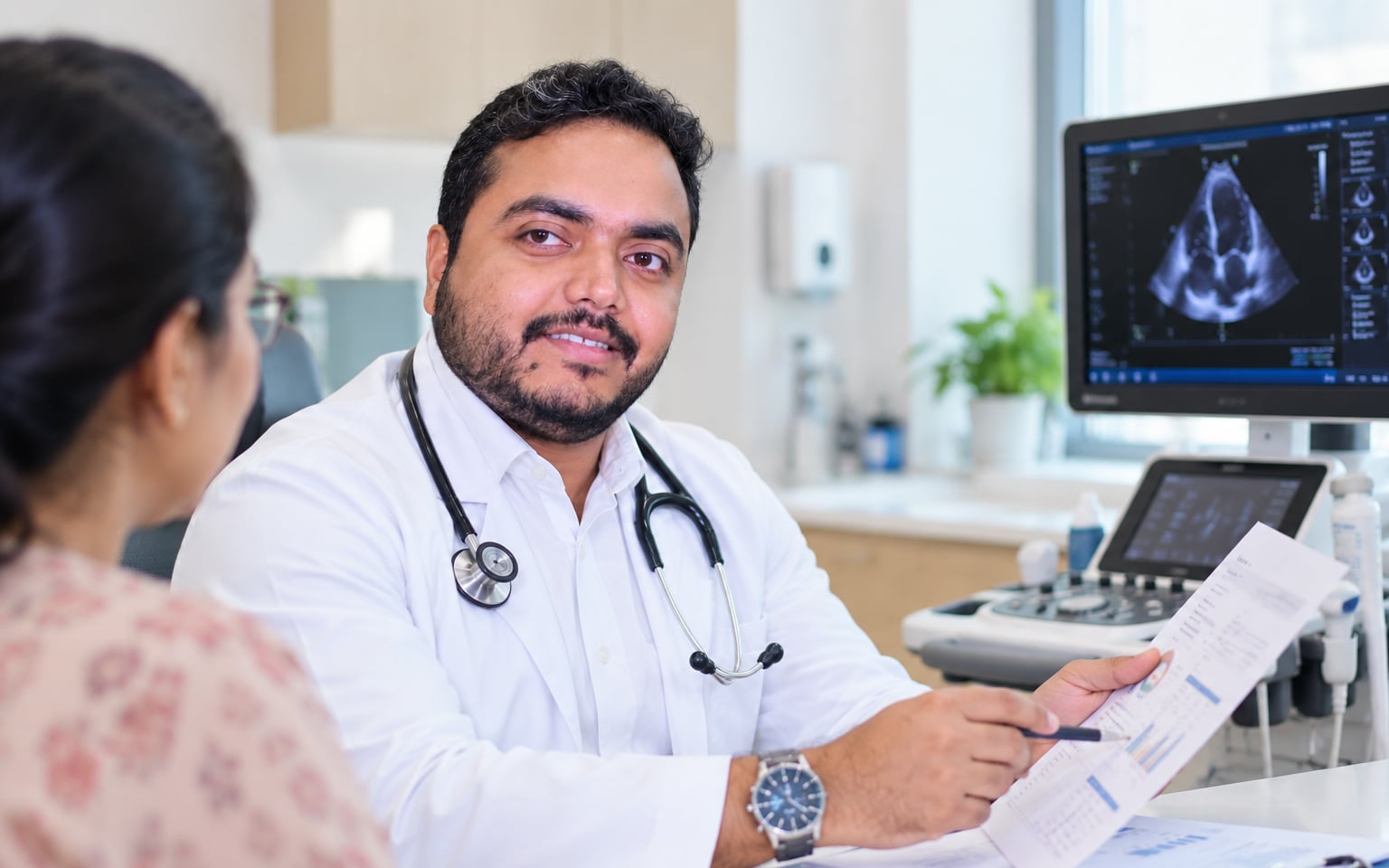 Dr. Tamoghna Das explaining a report to a patient during a consultation at Medcare
